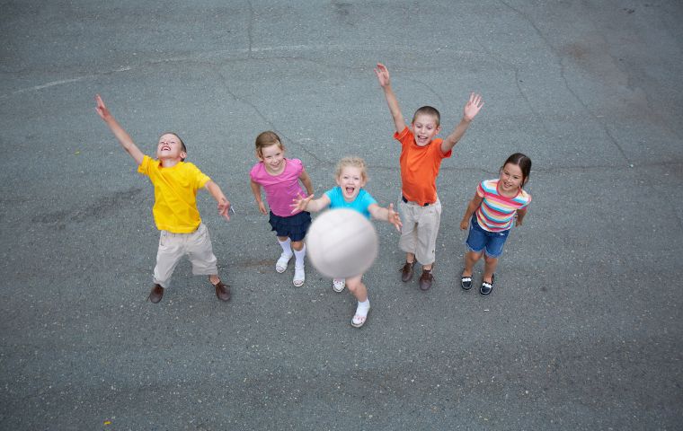 children throwing netball in the air